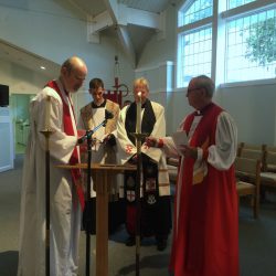 The host Bishop † Carl Buffington, his deputy Pastor Christopher Caudle and in-house counsel Canon Kevin † Donlon witness the oath of consecration.